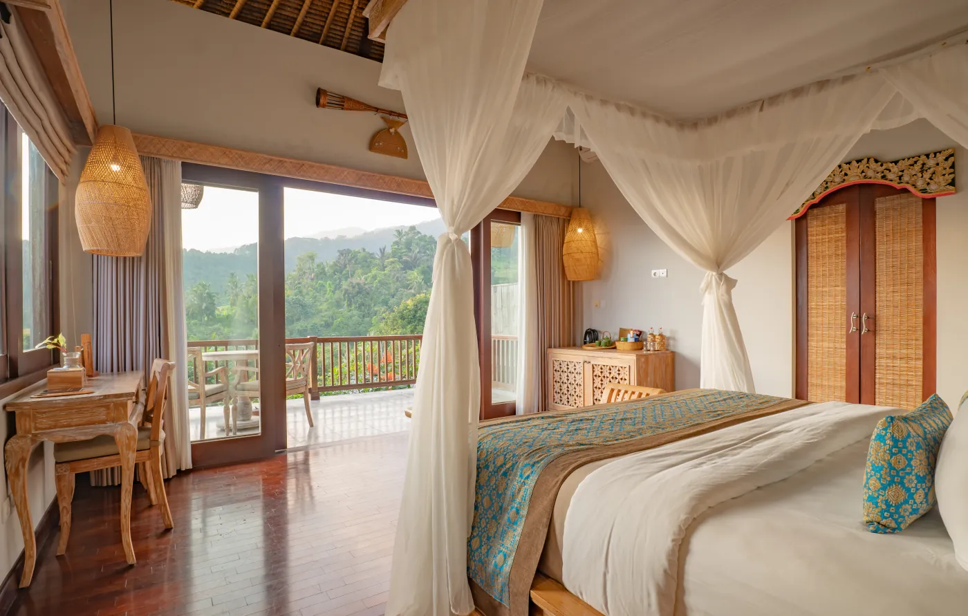 Canopy bed beside a window with a view of the forested hills